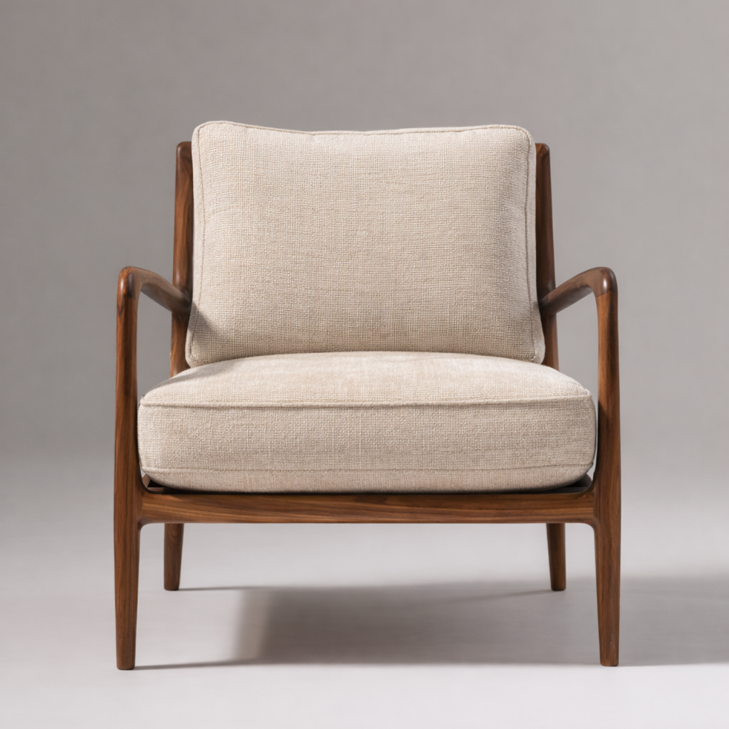 Calder Lounge Chair side view showing sculpted armrest and tapered wood legs