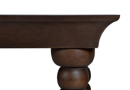 Close-up detail of the Monolith Console Table in dark walnut oak, showcasing its sculptural rounded leg design and handcrafted solid wood construction.