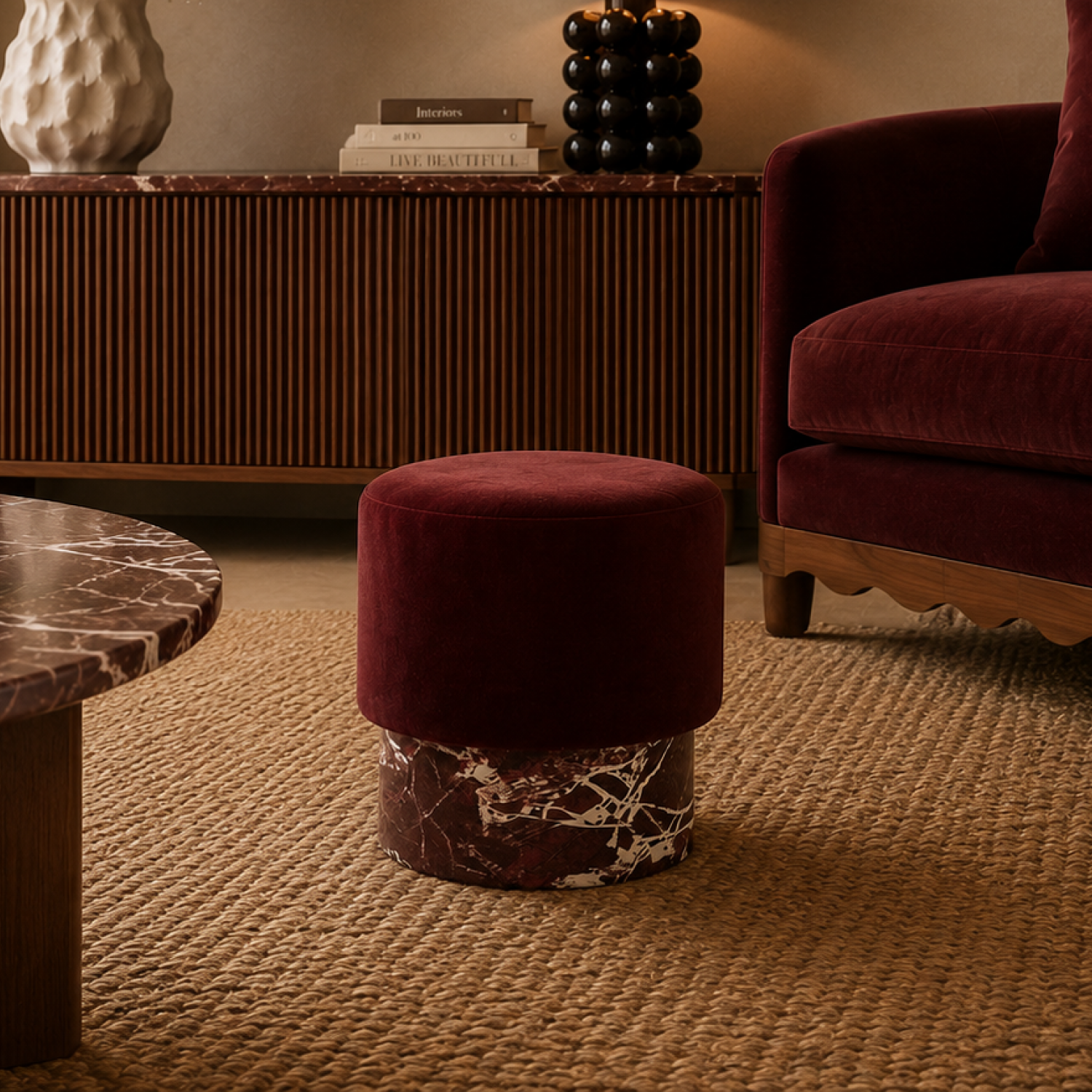 Vesper Ottoman in a modern luxury living room with burgundy velvet upholstery